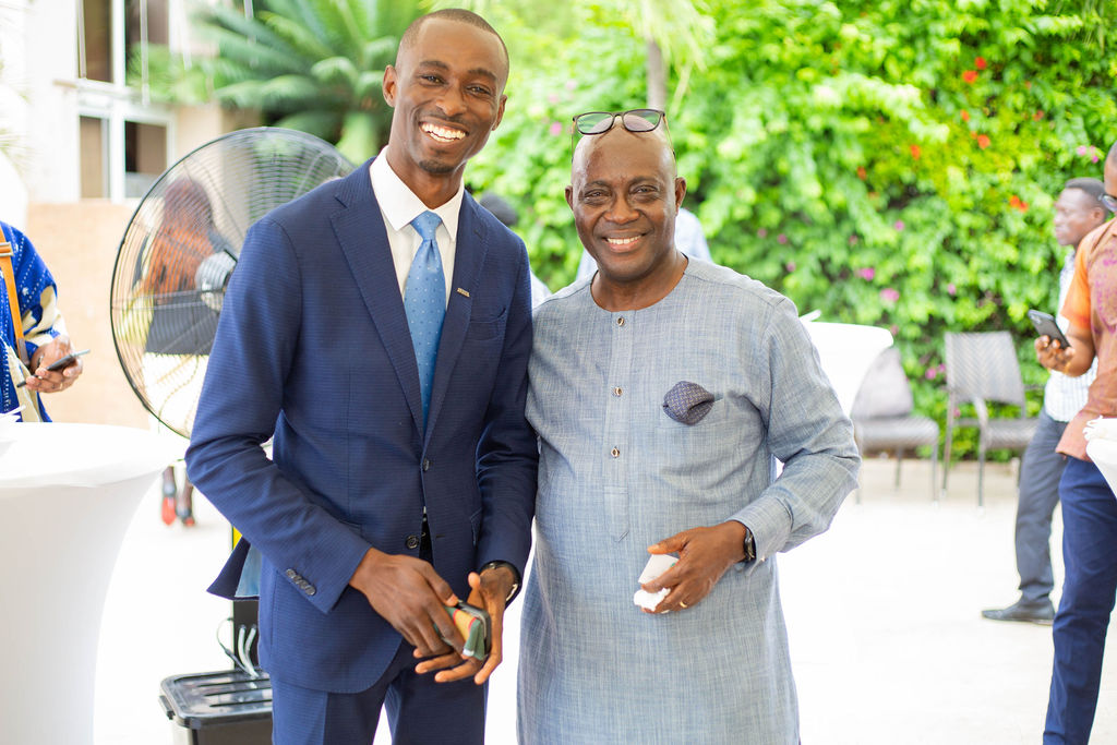 King David Amo greeting a guest of honour at an outdoor event