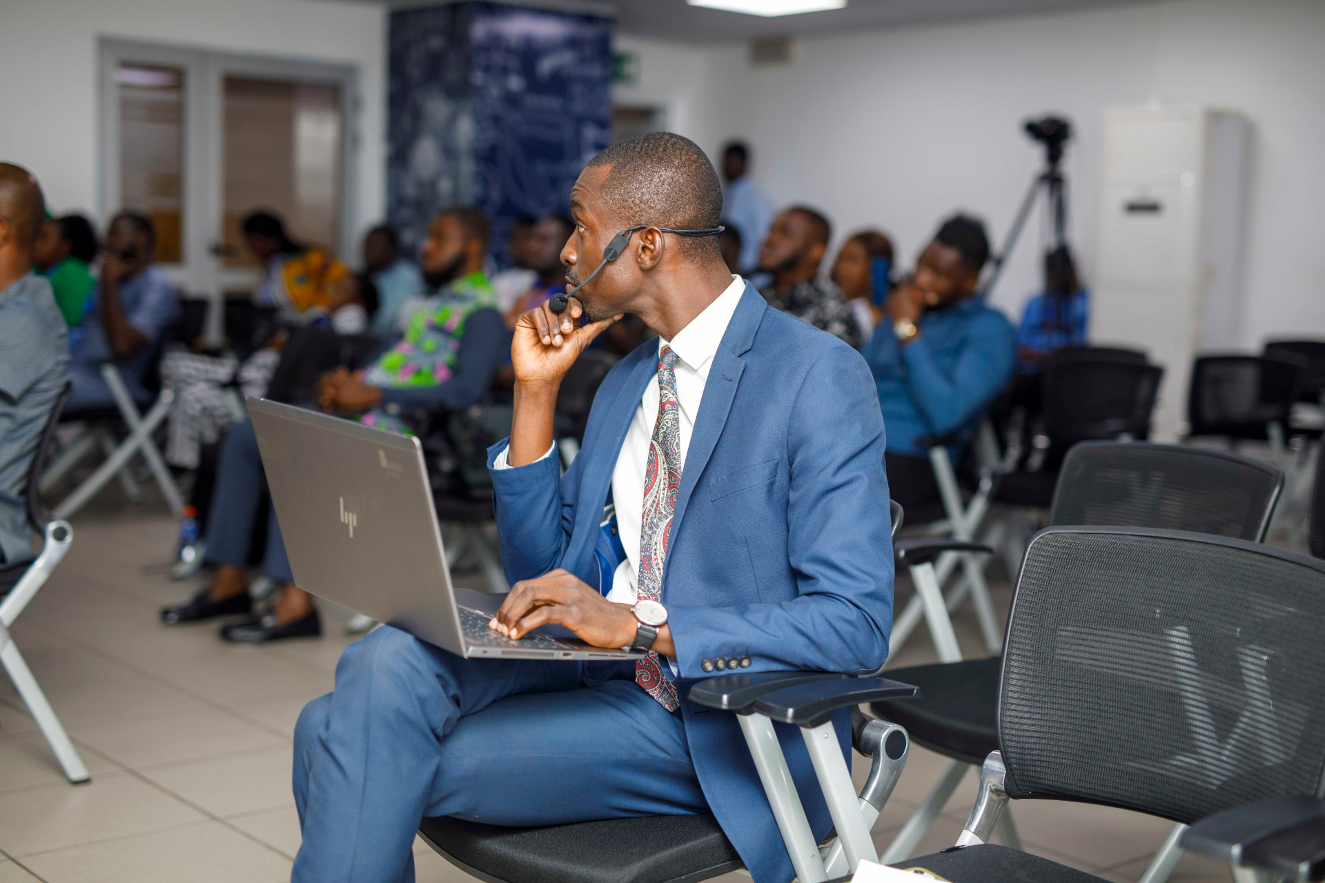 King David Amo following a session from the audience with a laptop and headset microphone